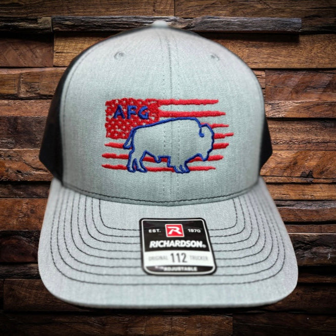Front view of Richardson 112 trucker hat with heather gray front, black mesh back, red flag and blue buffalo embroidery, and blue AFG stitched above buffalo.