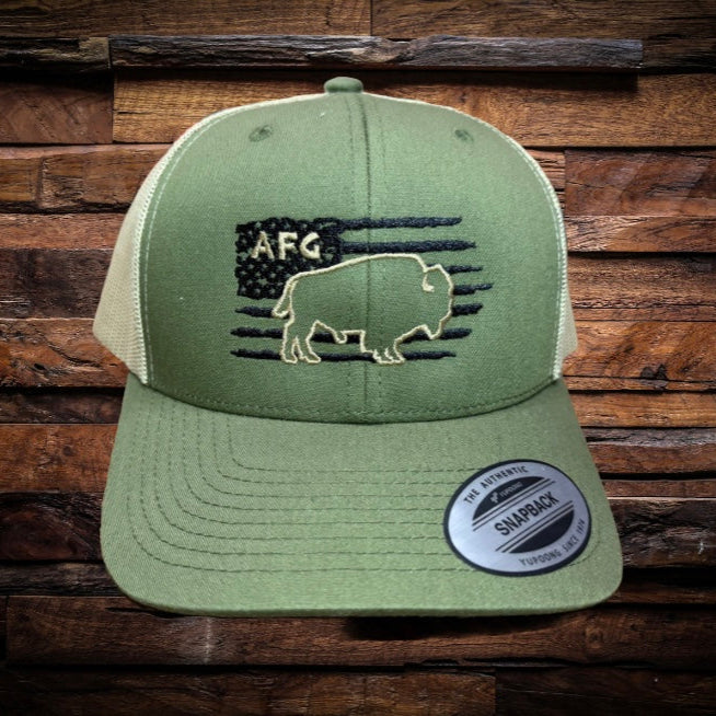 Front view of Yupoong 6606 snapback hat with olive green front, tan mesh back, black flag and buffalo embroidery with white outline, and AFG stitched above buffalo.